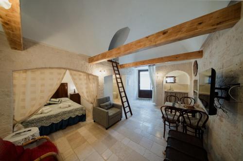 a bedroom with a bed and a staircase in a room at Casa del Ramaiolo in Alberobello