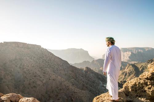 a man standing on top of a mountain at Anantara Al Jabal Al Akhdar Resort in Al ‘Aqar
