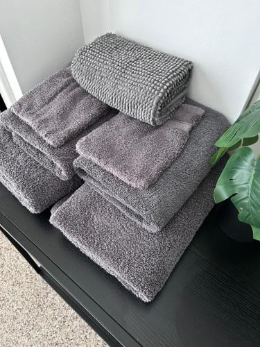 a stack of grey towels sitting on a shelf at Mariafarm Boutique Hotel in Zevenbergen