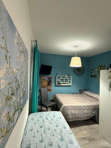 ein Schlafzimmer mit zwei Betten und blauen Wänden in der Unterkunft Collis Iani - Experience in Colliano