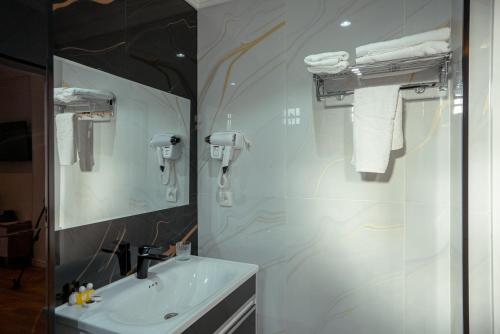 a bathroom with a sink and a mirror at Asal Boutique Hotel in Bukhara