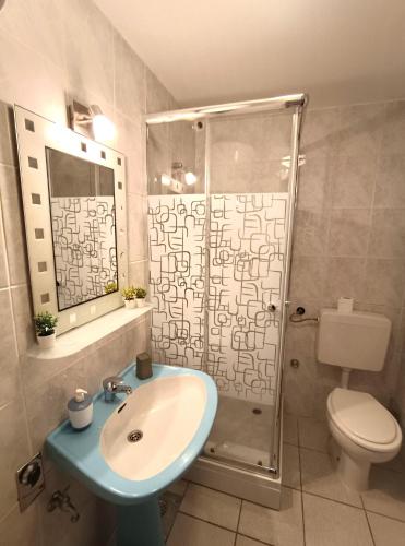 a bathroom with a sink and a shower at Apartments Vuleta in Pag
