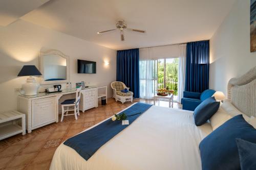 a hotel room with a large bed and a desk at BlueBay Banús in Marbella
