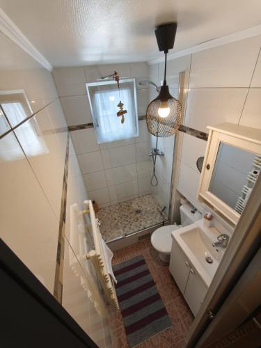 a small bathroom with a toilet and a sink at Stephan house in Tremblay-En-France