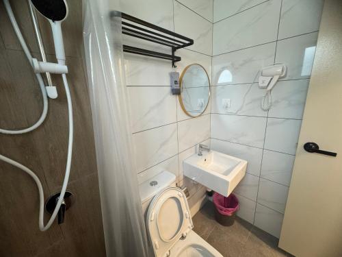 a bathroom with a toilet and a sink at Piccadilly Greentown Ipoh by Jun - City Views in Ipoh
