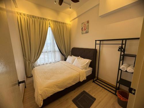 a small bedroom with a bed and a window at Piccadilly Greentown Ipoh by Jun - City Views in Ipoh