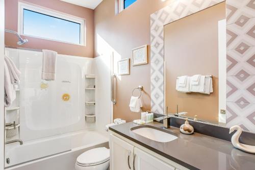 a bathroom with a sink and a toilet and a mirror at BP07FLR Big Pine Key Dreams in Big Pine Key