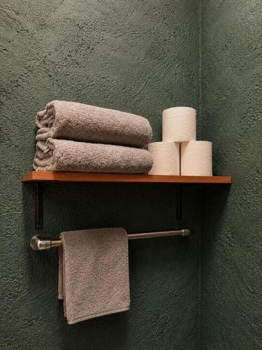 a shelf with towels and towels on a wall at Casa Paco Siargao in Catagnan