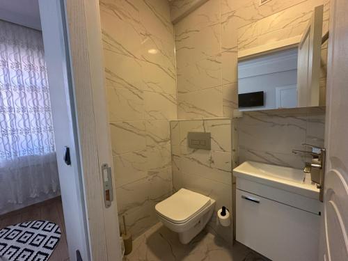 a bathroom with a toilet and a sink at Mürefte Suite in Tekirdağ