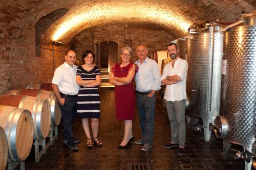 a group of people standing in a wine cellar at Agriturismo Rivella in Barbaresco
