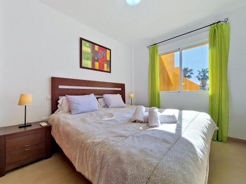 a bedroom with a large bed and a window at Albatros Playa 3 - 3409 in Mar de Cristal