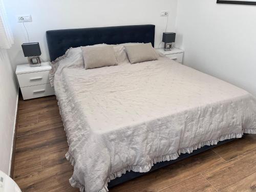 a bedroom with a large bed with two night stands at Apartman Quattro 2 in Međugorje