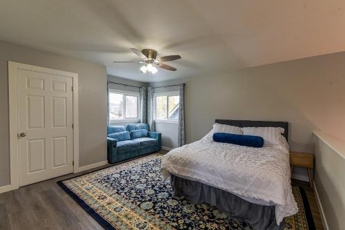 a bedroom with a bed and a couch and a ceiling fan at The Palouse Perch in Moscow