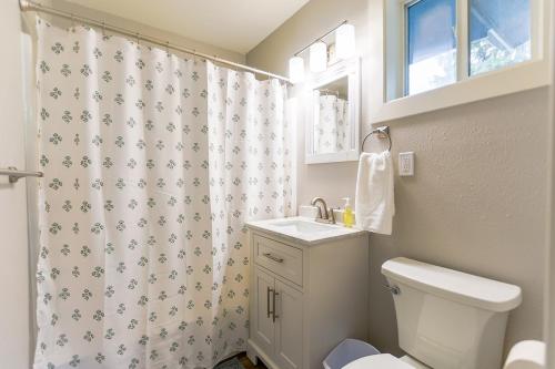 a bathroom with a toilet and a shower curtain at The Palouse Perch in Moscow