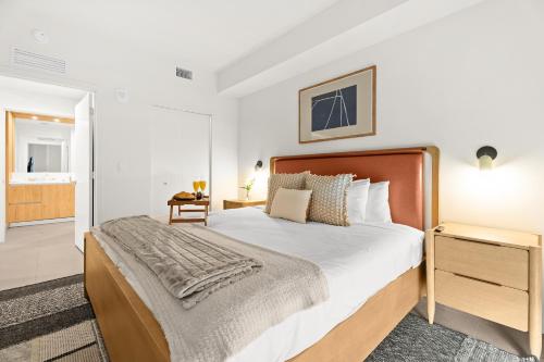a bedroom with a large bed with a wooden headboard at 1Bd Top Location Downtown Miami in Miami