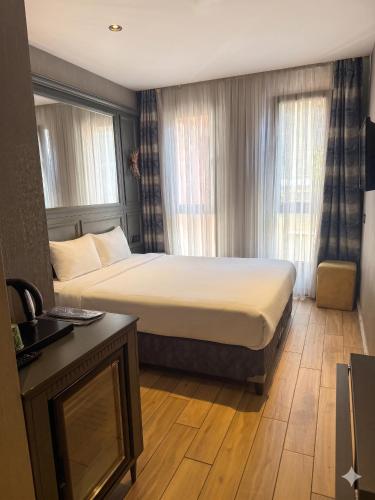 a hotel room with a bed and a desk at Peri Boutique Hotel Taksim in Istanbul