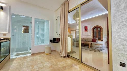 a living room with a large glass door to a living room at Villa familiale avec piscine privée sans vis à vis in Oulad Raho