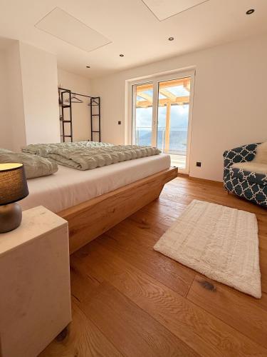 a bedroom with a large bed and a large window at Apartment Bergliebe in Sellrain