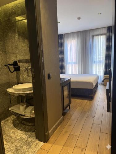 a bedroom with a bed and a tub in a room at Peri Boutique Hotel Taksim in Istanbul
