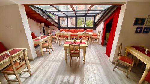 a restaurant with tables and chairs and a glass ceiling at "VILLA DENY" Boutique HOTEL - with FREE PARKING in Mostar
