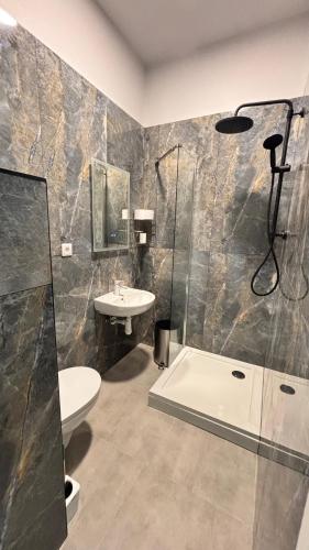a bathroom with a sink and a toilet and a shower at Orinoko Guest House in Stacija Sece