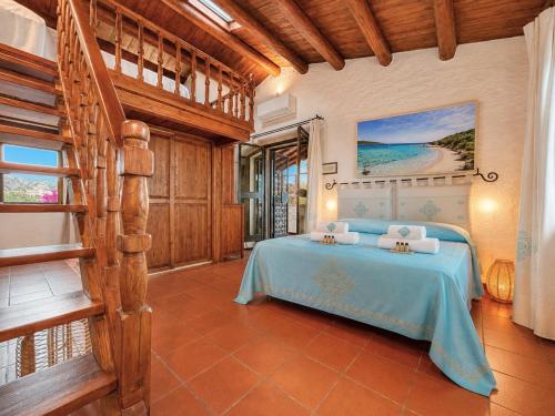 a bedroom with a bed and a staircase in a room at Panoramic Sea View Apt 4 Close to the Beach With Pool in Baja Sardinia