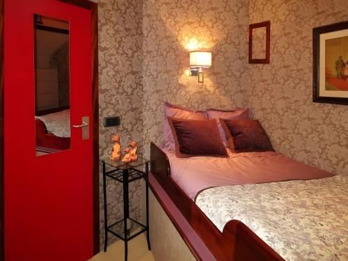 a red bedroom with a bed and a red door at Péniche - Eden in Samois-sur-Seine