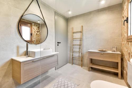 a bathroom with a sink and a mirror at Villa AmberBlue Kalathos in Kalathos