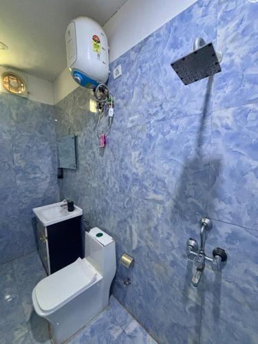 a bathroom with a white toilet and a shower at GoBravo 48 - 2BHK Farm with Pool and Garden Sector 150 Noida in Greater Noida