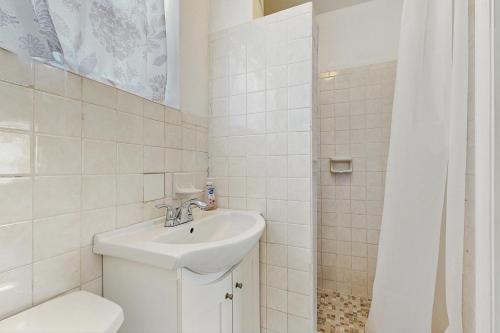 a white bathroom with a sink and a toilet at CK03 Fisherman's Retreat in Conch Key