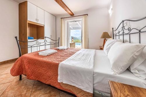 a bedroom with a large bed with two towels on it at Villa Morfeas in Nydri