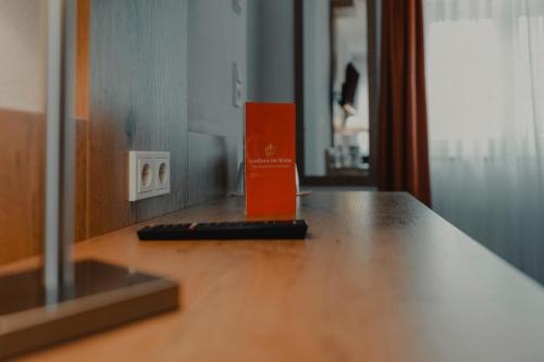 an orange box sitting on top of a wooden table at Gasthaus zur Krone in Weingarten (Karlsruhe)