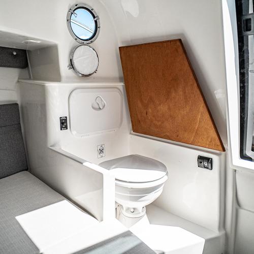 a small bathroom with a toilet and a mirror at Hugo Experience - Taormina boat tour in Taormina