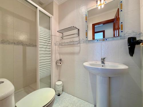 a bathroom with a sink and a toilet and a mirror at Apartamento Playa Azul - 5924 in Arnuero