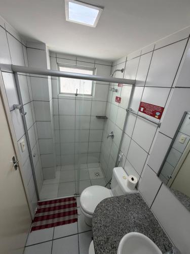 a bathroom with a shower and a toilet and a sink at Hotel Ideal in Teresina