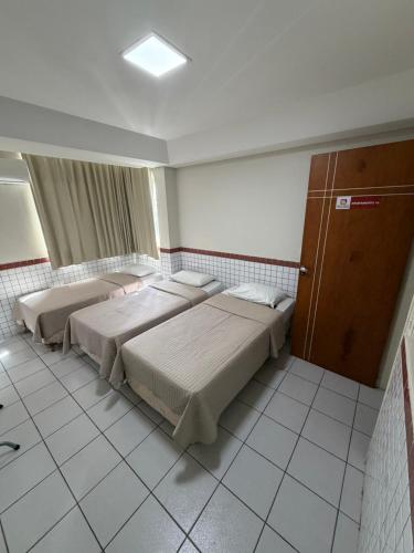 a hotel room with two beds in a room at Hotel Ideal in Teresina