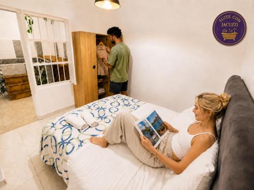 a woman laying on a bed in a bedroom at Lienzo Hostal Popayán in Popayan