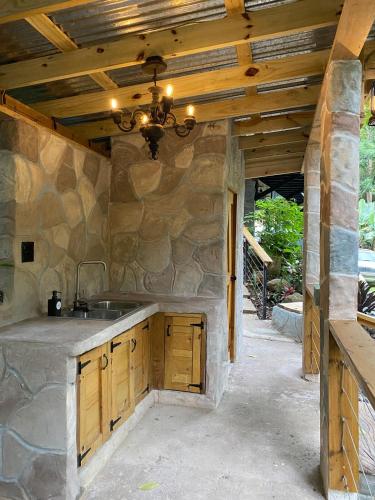 a kitchen with a sink and a wooden ceiling at Hidden Cabins Puerto Rico in Comerio