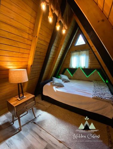 a bedroom with a large bed in a attic at Hidden Cabins Puerto Rico in Comerio