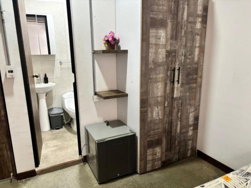a bathroom with a toilet and a sink and a mirror at La Curva in Cali