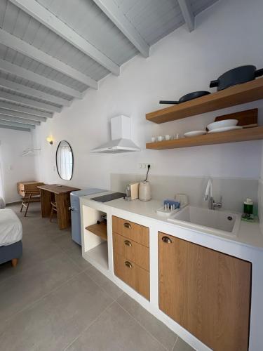 a kitchen with a sink and a counter top at Nikolas Rooms in Loutro