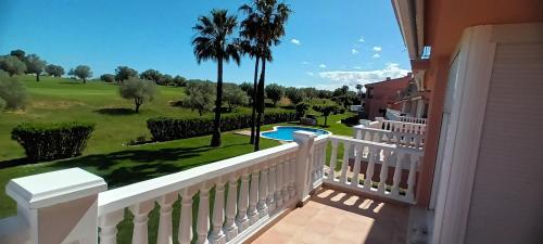 a balcony of a house with a view of a yard at Naturaleza y Golf in San Jorge