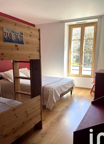 a bedroom with two bunk beds and a window at Entre ciel et montagnes in Cauterets