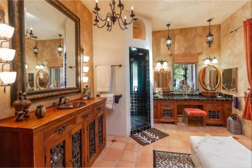 a bathroom with a sink and a large mirror at The Bubbling Wells Oasis, 3 Homes on 107 Acres in Desert Hot Springs