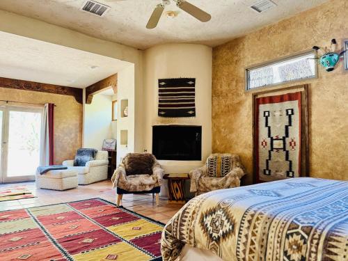 a bedroom with a bed and a flat screen tv at The Bubbling Wells Oasis, 3 Homes on 107 Acres in Desert Hot Springs