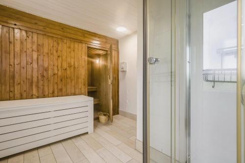 a bathroom with a walk in shower and a wooden wall at 6 Bed in Hersham oc-t29211 in Stratton
