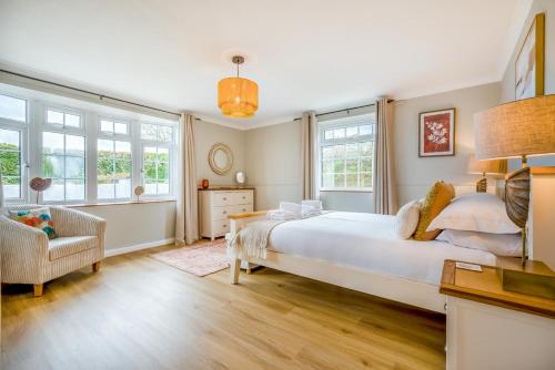 a bedroom with a large white bed and windows at 6 Bed in Hersham oc-t29211 in Stratton