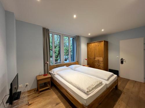 a bedroom with a large bed and a window at Hotel Sternen Budget in Lenk