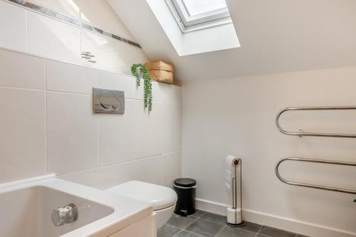 a bathroom with a white toilet and a sink at 3 Bed in Tenby oc-93359 in Redberth
