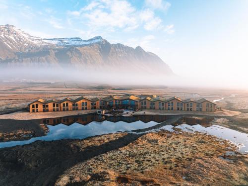 an aerial view of a lodge with mountains in the background at Hótel Jökulsárlón - Glacier Lagoon Hotel in Gerdi
